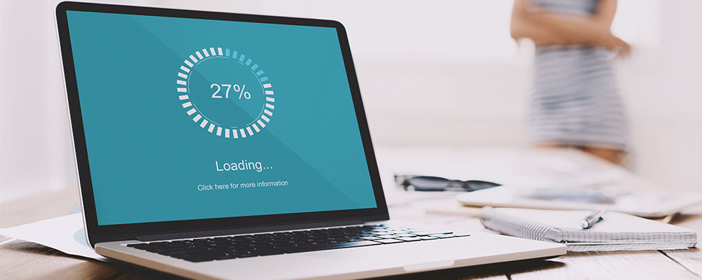 Why is my WordPress site loading so slow. Image of a laptop open with a loading screen displayed