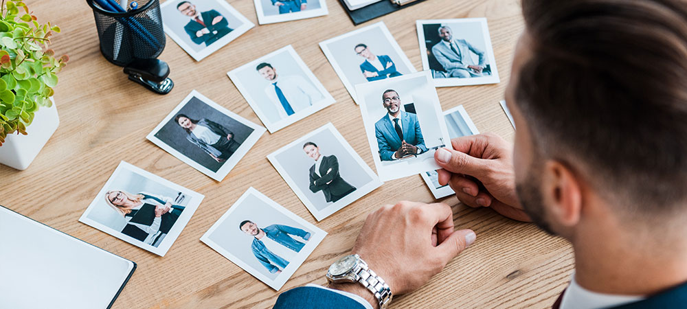 person selecting profile shots of different men and women to determine the brand persona they want to go for