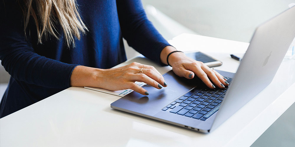 woman on laptop performing on page seo checks