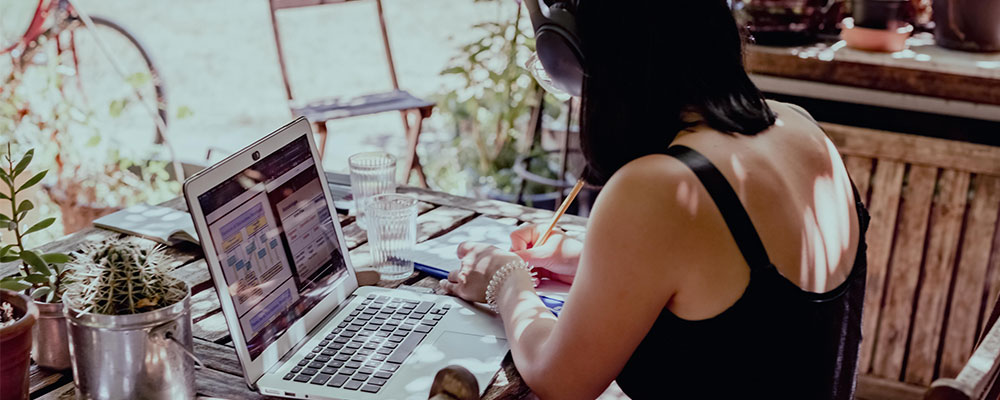 Is it too late to learn web design? This image illustrates a woman learning web development