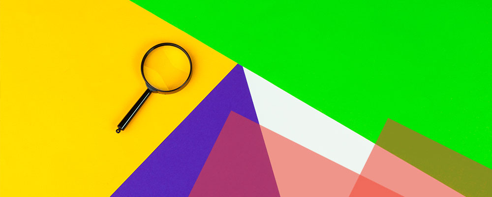 image with a colorful abstract background with a magnifying glass sitting on top